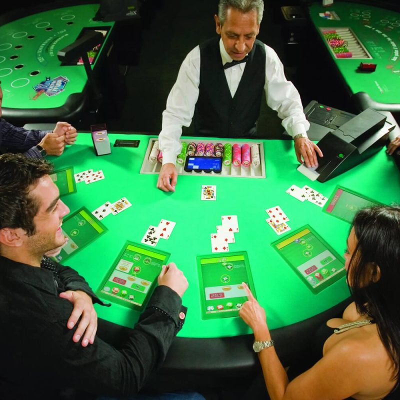 People playing Blackjack at a Zytronic technology interactive casino table