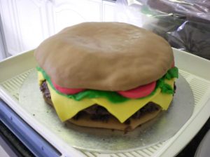 An iced cake designed to look like a burger for a Zytronic charity event
