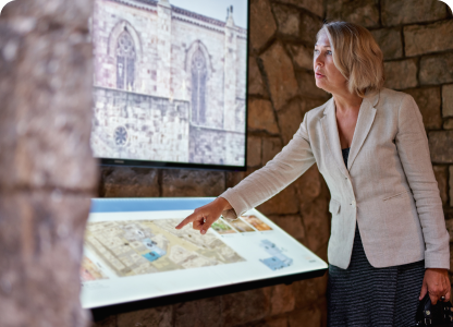 A woman using a touchscreen to educate people