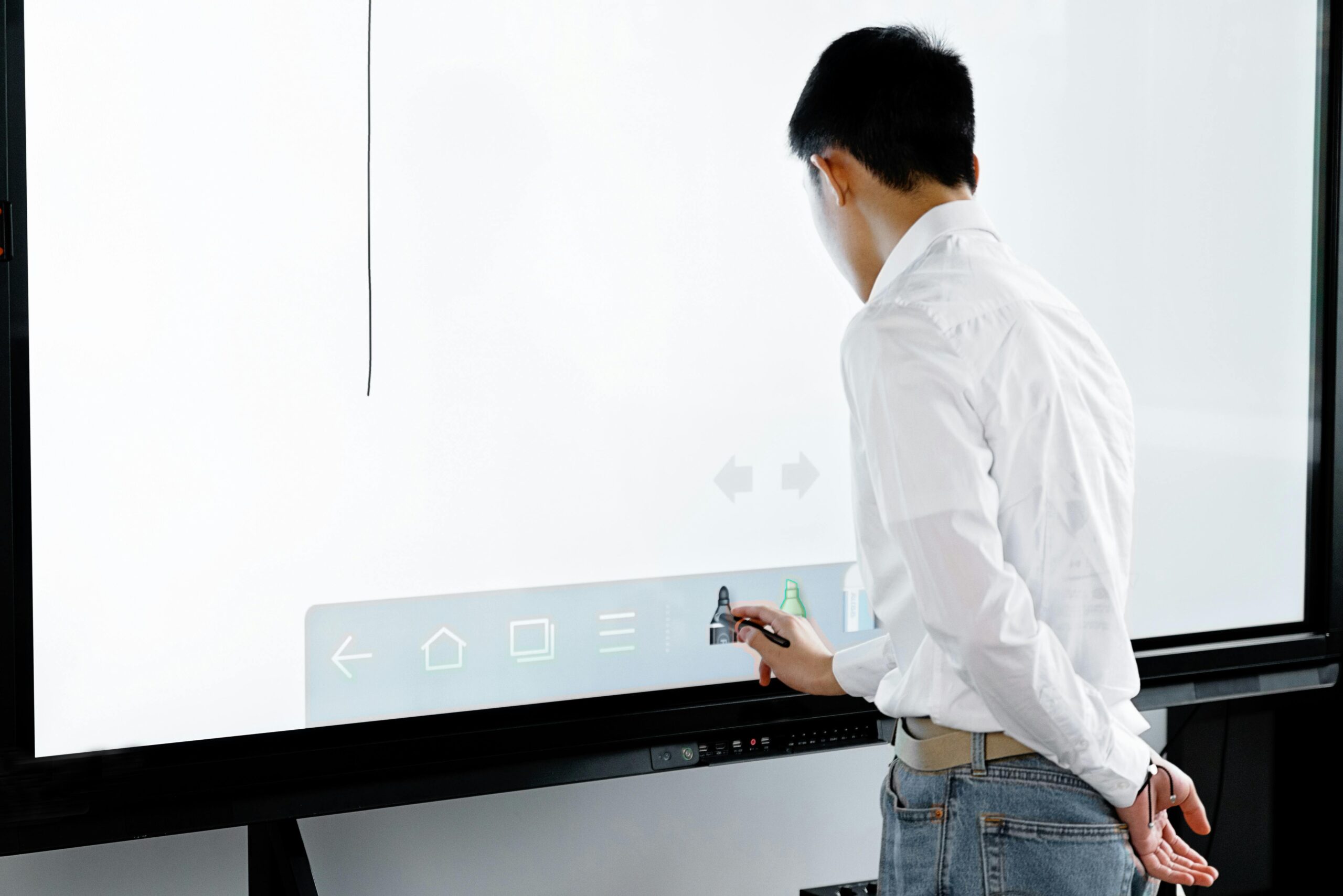 A man using a touchscreen whiteboard